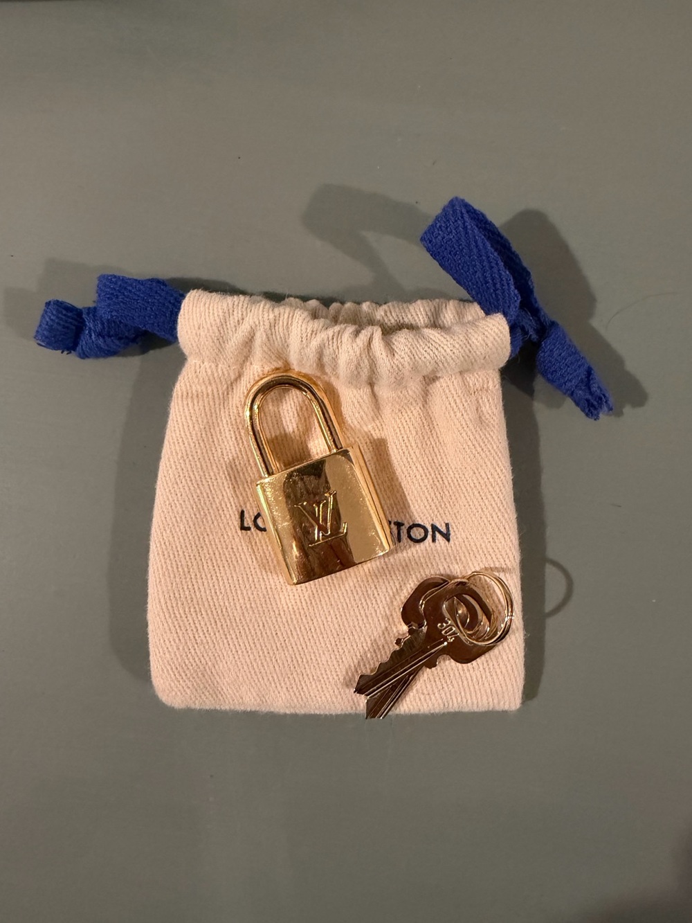 Louis Vuitton Gold Padlock and Key Set with Cream Pouch and Blue Drawstrings